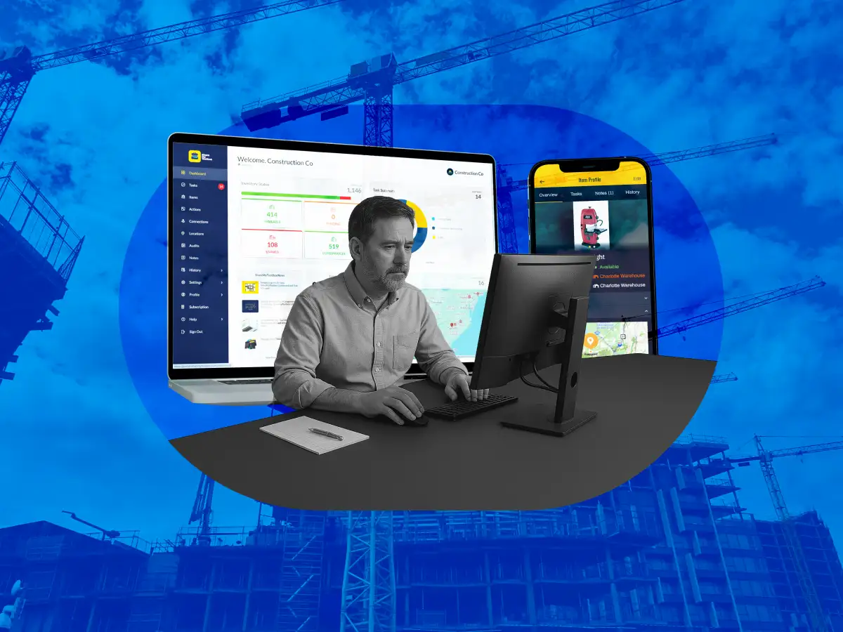 construction owner sitting at a desk managing tools with ShareMyToolbox with a background of a job site with cranes